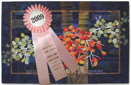 Image - bue quilt with pink award ribbon