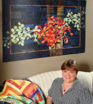 Image - Ellen Lindner in front of bright quilt